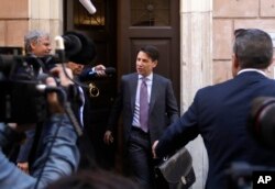 Italian Premier-designate Giuseppe Conte (C) is approached by journalists as he leaves his home, in Rome, May 24, 2018.
