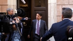 Italian Premier-designate Giuseppe Conte (C) is approached by journalists as he leaves his home, in Rome, May 24, 2018. 
