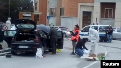 Forensics experts inspect a car used by a gunman in Macerata, Italy, Feb. 3, 2018. Forensics experts inspect a car used by a gunman in Macerata, Italy, Feb. 3, 2018. 