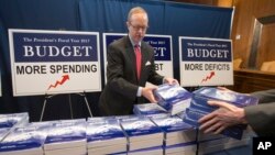 President Barack Obama’s final fiscal 2017 budget proposal are displayed by Eric Euland, Republican staff director for Sen. Mike Enzi, R-Wyo., chairman of the Senate Budget Committee, on Capitol Hill, Feb. 9, 2016. 