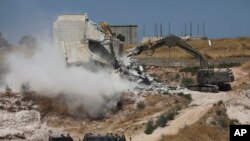 Israeli forces destroy a building in a Palestinian village of Sur Baher, east Jerusalem, July 22, 2019.