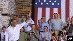 President Barack Obama arrives at a town hall meeting at Wyffels Hybrids Inc., in Atkinson, Illinois, during his three-day economic bus tour, August 17, 2011