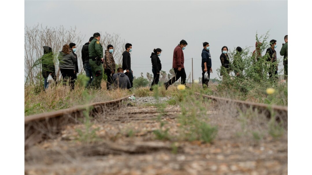 Central American migrants wait to be transported by the U.S. Border Patrol after crossing the Rio Grande River into the U.S. from Mexico in La Joya, Texas, April 27, 2021.