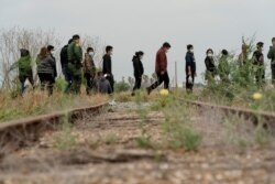 Central American migrants wait to be transported by the U.S. Border Patrol after crossing the Rio Grande River into the U.S. from Mexico in La Joya, Texas, April 27, 2021.