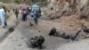FILE - Police officers examine the site of suicide bombing at a highway in Shangla, district in the Pakistan's Khyber Pakhtunkhwa province, March 26, 2024. A suicide bomber in northwest Pakistan killed five Chinese nationals and their Pakistani driver, officials said.
