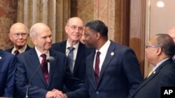 Mormon church President Russell M. Nelson shakes hands with Derrick Johnson, president of the NAACP during a news conference, May 17, 2018, in Salt Lake City. 