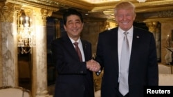 FILE - Japan's Prime Minister Shinzo Abe meets with U.S. President-elect Donald Trump (R) at Trump Tower in Manhattan, New York, Nov. 17, 2016.