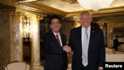 Japan's Prime Minister Shinzo Abe meets with U.S. President-elect Donald Trump at Trump Tower in New York, on November 17, 2016. Cabinet Public Relations Office/HANDOUT via Reuters