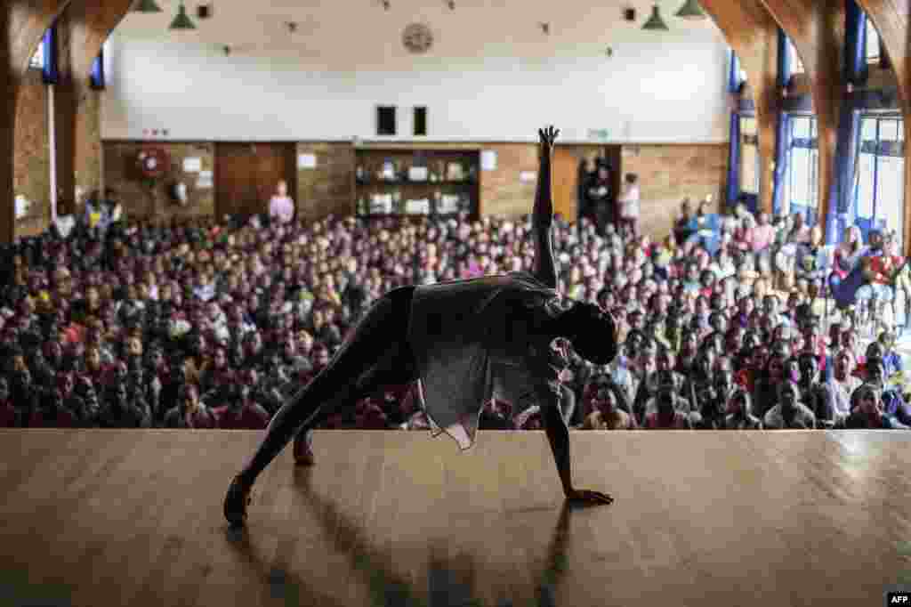 Joburg Ballet senior soloist Kitty Phetla performs in front of an audience of schoolchildren as part of a dance awareness event by the City Ballet at Park Senior School in Johannesburg, South Africa.