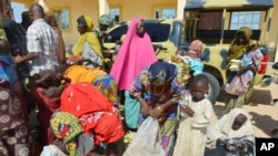 Women and children rescued by Nigerian soldiers from Boko Haram extremists in northeast Nigeria arrive at the military office in Maiduguri, Nigeria, July 30, 2015. 