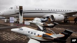 Miniature models of planes by Brazilian aircraft manufacturer Embraer sit on display at the Latin American Business Aviation Conference and Exhibition (LABACE) 2013 annual meeting at the Congonhas airport in Sao Paulo, Brazil, Aug. 14, 2013. 