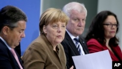 From left, Sigmar Gabriel, Chairman of the German Social Democrats, German Chancellor Angela Merkel, Horst Seehofer, Chairman of the German Christian Social Union and German Labor Minister Andrea Nahles address the media during a press conference in Berlin, Germany, Thursday, April 14, 2016, on the results of a meeting of the heads of the German government coalition.