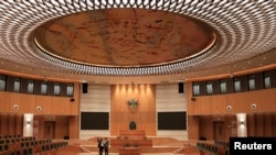 Visitors standing inside the Chinese-funded Parliament building in Mt. Hampden