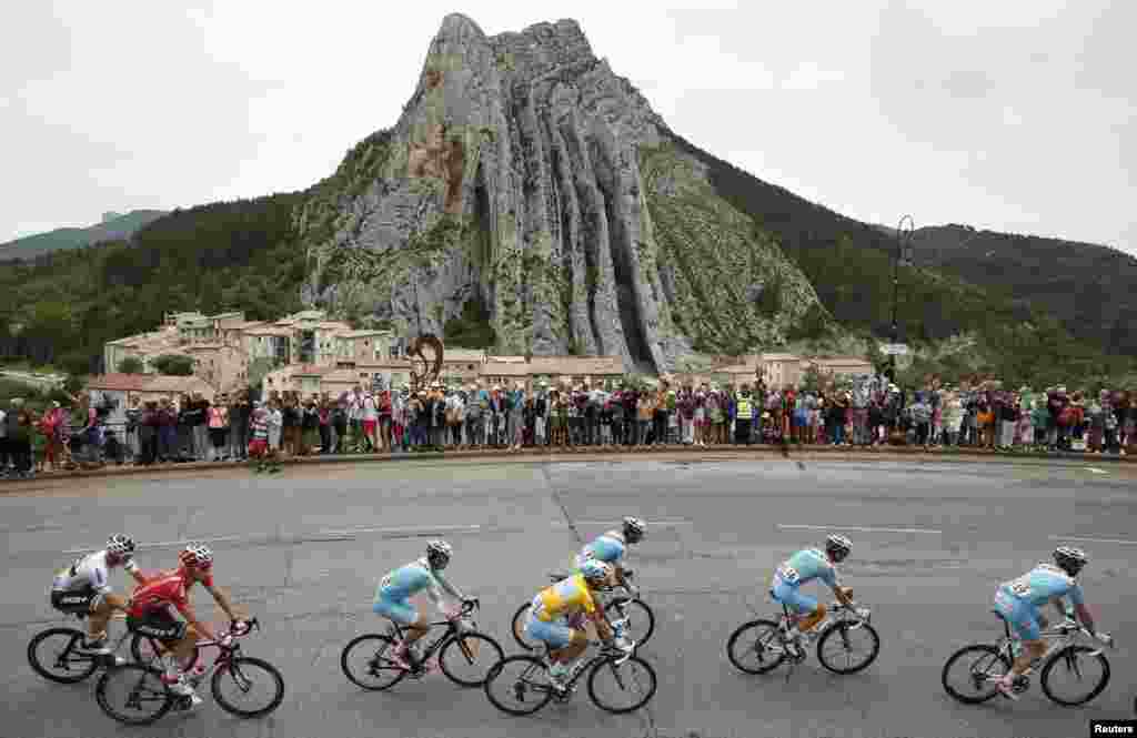 A pack of riders including race leader Astana team rider Vincenzo Nibali (C) of Italy cycles past Sisteron during the 222-km 15th stage of the Tour de France cycling race between Tallard and Nimes.