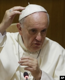 FILE - Pope Francis delivers his speech in the Synod Hall during a conference on Modern Slavery and Climate Change at the Vatican, July 21, 2015.