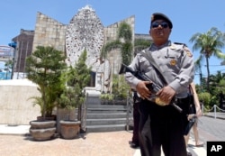 A police officers stands at the memorial of the 2002 Bali bombing site in Bali, Indonesia, Jan. 15, 2016.