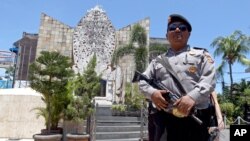 A police officers stands at the memorial of the 2002 Bali bombing site in Bali, Indonesia, Jan. 15, 2016.