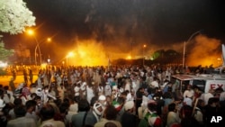 Pakistani protesters run during clashes near prime minister's home in Islamabad, Aug. 30, 3014.