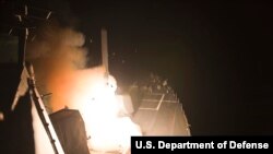FILE- The guided-missile destroyer USS Arleigh Burke, deployed in the U.S. 5th Fleet, launches Tomahawk cruise missiles during maritime security operations, Red Sea, Sept. 23, 2014.