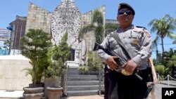 A police officers stands at the memorial of the 2002 Bali bombing site in Bali, Indonesia, Jan. 15, 2016. 