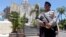 A police officers stands at the memorial of the 2002 Bali bombing site in Bali, Indonesia, Jan. 15, 2016. 