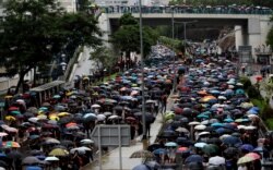 People take part in the "Reclaim Hung Hom and To Kwa Wan, Restore Tranquility to Our Homeland" demonstration against the extradition bill in To Kwa Wan neighborhood, Hong Kong, Aug. 17, 2019.