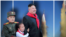 North Korea leader with rockets and kids