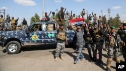 FILE - Iraqi security forces prepare to attack Islamic State positions in Tikrit, 130 kilometers (80 miles) north of Baghdad, Iraq, March 26, 2015.