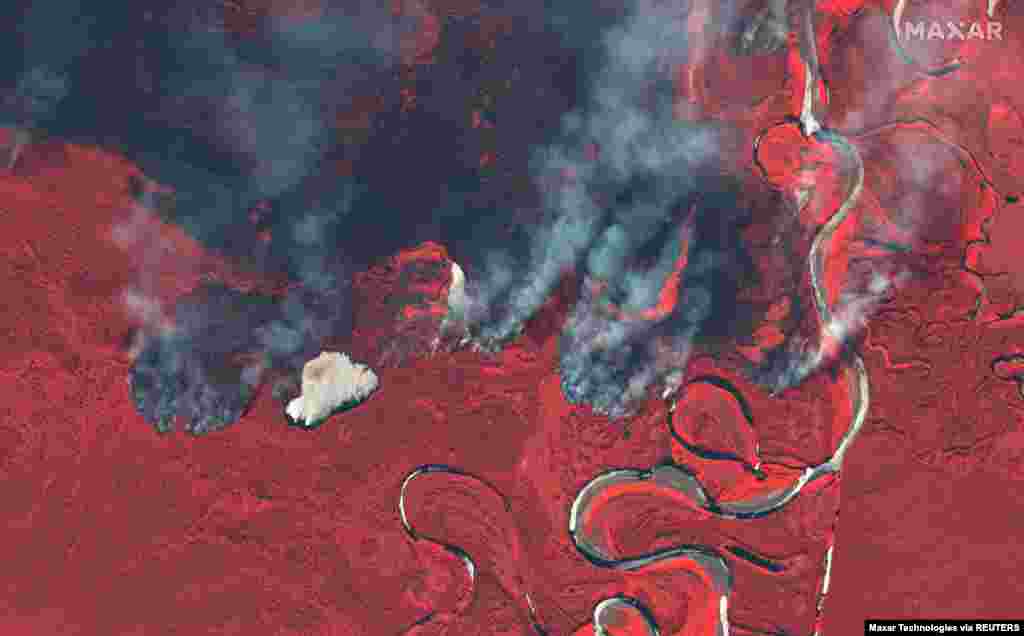 Smoke rises from wildfires near Berezovka River in Russia in this June 23, 2020 color infrared image provided by Maxar Technologies.