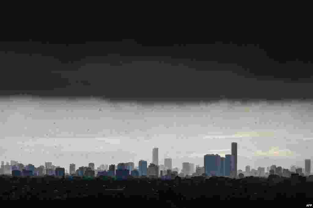 Dark clouds loom over the Hanoi skyline during a heavy downpour, Vietnam.