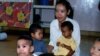 A group of Cambodian orphans gather and play while an orphanage worker looks on (File photo). 