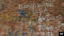 FILE - Anti-U.S. and Israeli slogans are written on the wall of the former U.S. Embassy in Tehran, Iran, Oct. 15, 2019.