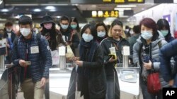 People wear masks at a metro station in Taipei, Taiwan, Tuesday, Jan. 28, 2020. 