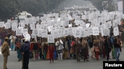 Women hold placards as they march during a rally organized by Delhi Chief Minister Sheila Dikshit (unseen) protesting for justice and security for women, in New Delhi, January 2, 2013.