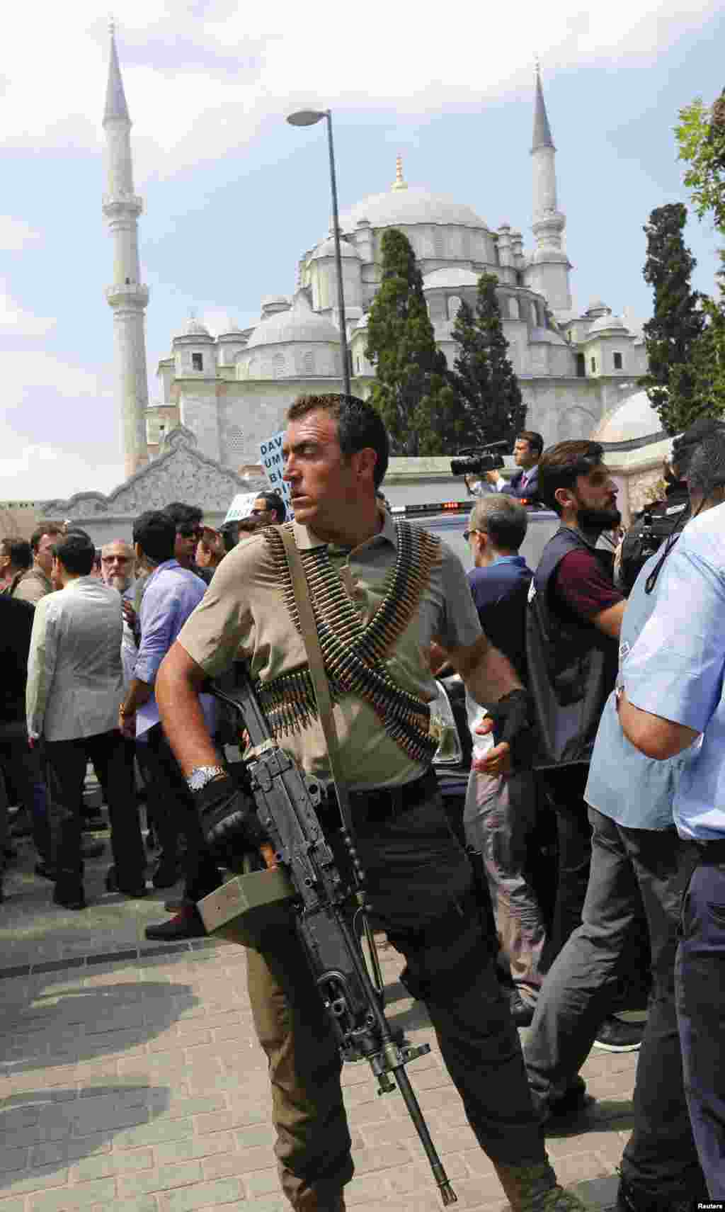 A heavily armed sniper guards the vehicle of President Recep Tayyip Erdogan following a funeral service at Fatih mosque for victims of a thwarted coup in Istanbul, July 17, 2016.