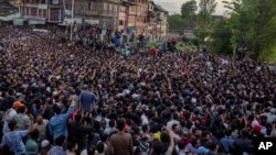 Kashmiri Muslims carry the body of Fayaz Ahmad Hamal, a local rebel, during his funeral procession in Srinagar, Indian-controlled Kashmir, May 5, 2018. Indian troops killed three suspected rebels Saturday in the main city in Indian-controlled Kashmir, officials said, while police blamed insurgents for killing three other men.