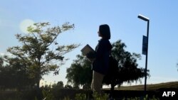 Overseas Chinese student Helen Zhou, from Chengdu, heads to Choir practice on campus at Linfield Christian School in Temecula, California 