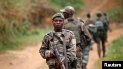 FILE - Democratic Republic of the Congo troops patrol against the Allied Democratic Forces and the National Army for the Liberation of Uganda rebels near Beni in North-Kivu province, Dec. 31, 2013.