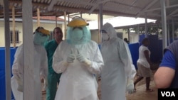 Cuban medical team training in personal protective equipment (PPE) at an Ebola center being built in Waterloo, east of Freetown, Sierra Leone, Nov. 17, 2014. (Nina deVries/VOA) 