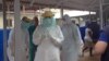 Cuban medical team training in personal protective equipment (PPE) at an Ebola center being built in Waterloo, east of Freetown, Sierra Leone, Nov. 17, 2014. (Nina deVries/VOA) 