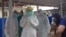 Cuban medical team training in personal protective equipment (PPE) at an Ebola center being built in Waterloo, east of Freetown, Sierra Leone, Nov. 17, 2014. (Nina deVries/VOA) 