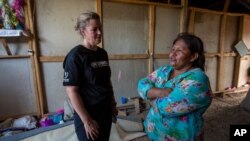 FILE - Francisca Ramirez, right, talks with Deputy High Commissioner for the U.N. Refugee Agency, Kelly Clements, in a community of Nicaraguan refugees, in Upala, Costa Rica, Feb. 8, 2020.
