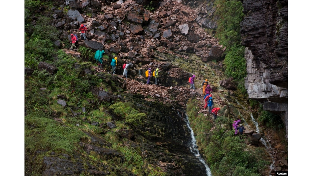 Tourists walk down from the top of Mount Roraima, near Venezuela's border with Brazil, Jan. 18, 2015.