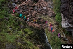 Tourists walk down from the top of Mount Roraima, near Venezuela's border with Brazil, Jan. 18, 2015.