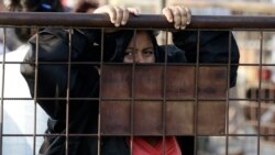 A relative of an inmate awaits news outside the Litoral Penitentiary in Guayaquil, Ecuador, Wednesday, September 29, 2021. (AP Photo/Angel DeJesus)