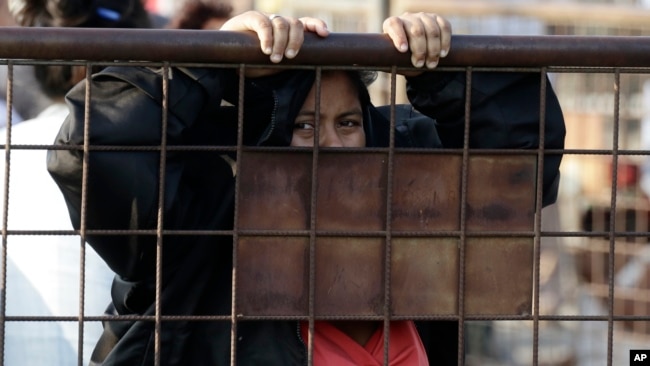 A relative of an inmate awaits news outside the Litoral Penitentiary in Guayaquil, Ecuador, Wednesday, September 29, 2021. (AP Photo/Angel DeJesus)