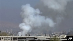 Image taken from video obtained from Shaam News Network, smoke rises from university buildings after shelling, Damascus, March 28, 2013.