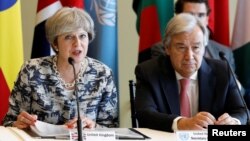FILE - British Prime Minister Theresa May speaks while United Nations Secretary-General Antonio Guterres attends a meeting on action to end modern slavery and human trafficking on the sidelines of the 72nd United Nations General Assembly at U.N. Headquarters in New York, Sept. 19, 2017.