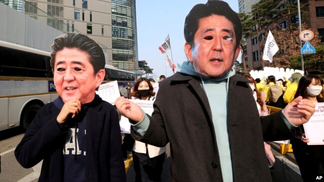 College students wearing masks of Japanese Prime Minister Shinzo Abe march toward Japanese embassy during a rally to mark the centennial of the March First Independence Movement Day against Japanese colonial rule (1910-45), in Seoul, South Korea, March 1, 2019.
