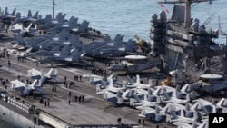 U.S. aircrafts sit on the flight deck of the USS George Washington at a navy port in Busan, South Korea, Oct. 4, 2013.